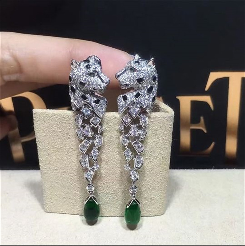 C Cheetah Earrings - showing the charm of courage, naughty or docile .310 round bright cut diamonds, emerald and onyx.