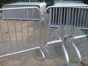Two pieces of crowd control barriers are connected with the two same size bridge feet and a detail picture of the bridge feet .