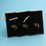 small velvet drawstring gift bag with satin lining inside with gold logo stamped