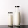 Buy cheap Silk Screen 25Oz 32Oz Milk Packaging Glass Bottle With Metal Lid Beverage Bottle from wholesalers