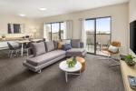 Fabric upholstery King size bed and laminate wood desk tables with luggage