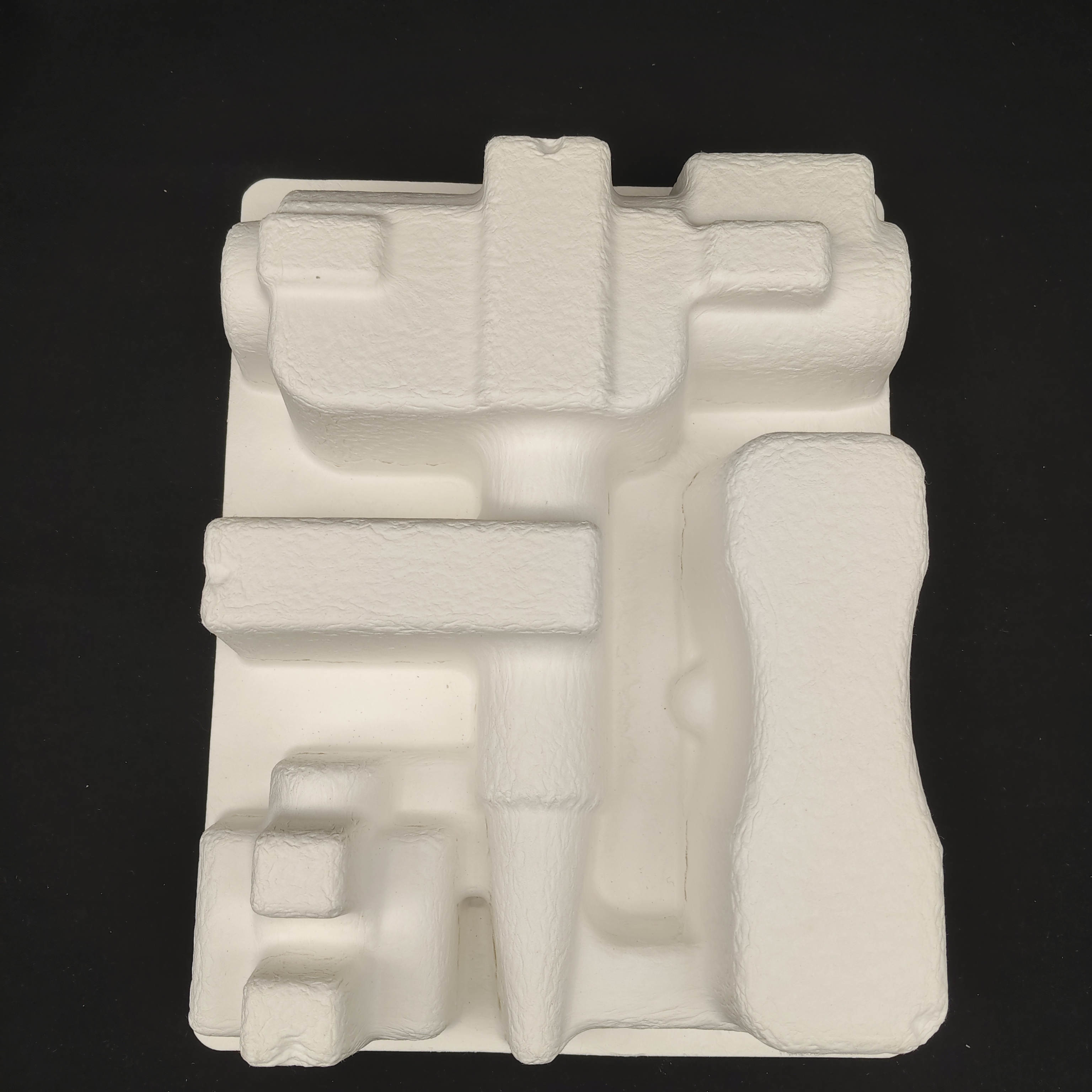 OEM manufacturers customize pulp molded packaging bases for small household appliance fascia guns. These are made of white plant fibers through dry