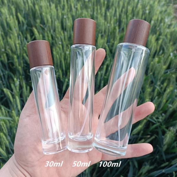 Buy cheap 50ml 100ml Perfume Spray Atomizer Bottle Bayonet Long Cylinder Wood Cap Glass from wholesalers