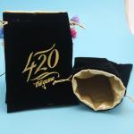 small velvet drawstring gift bag with satin lining inside with gold logo stamped