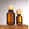 Buy cheap New Luxury Cylinder Shape Amber Spray Glass Bottle 30ml 50ml 100ml Cosmetic Amber Perfume Bottle With Round Wooden Lids from wholesalers
